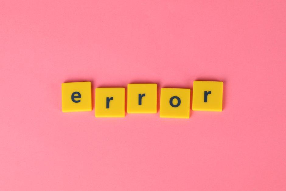 Yellow block letters spelling 'error' on a vibrant pink background, capturing a playful message.