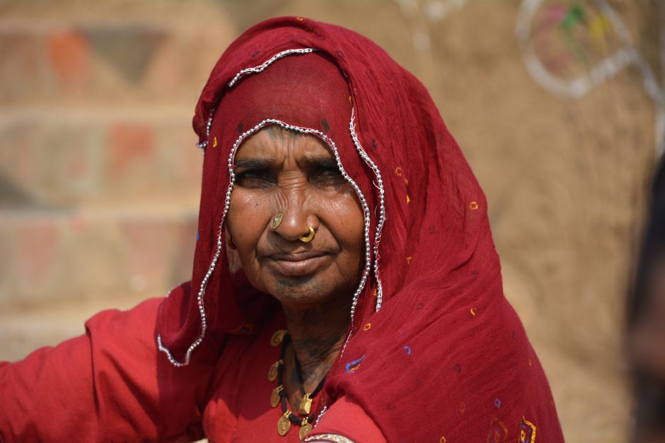 Elderly Indian woman in vibrant traditional attire, captured at Surajkund Mela, Faridabad.