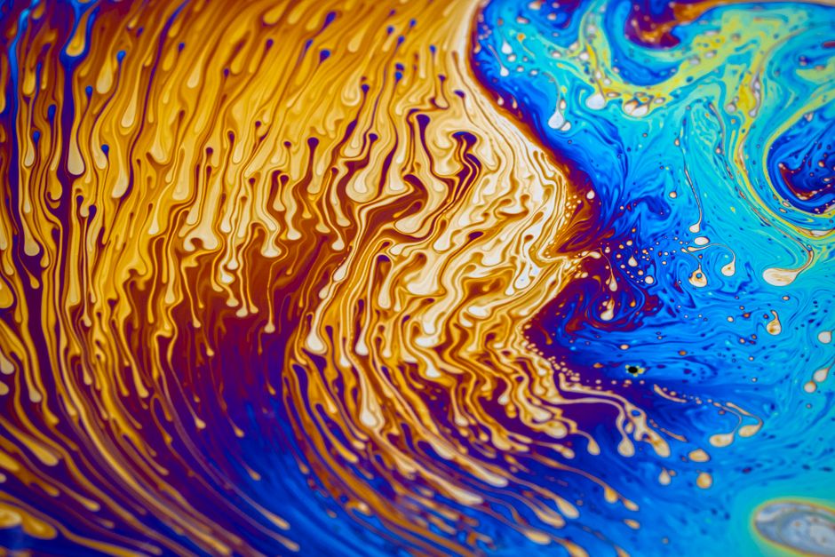 A dynamic blend of vibrant blue and yellow colors creating stunning abstract liquid art.